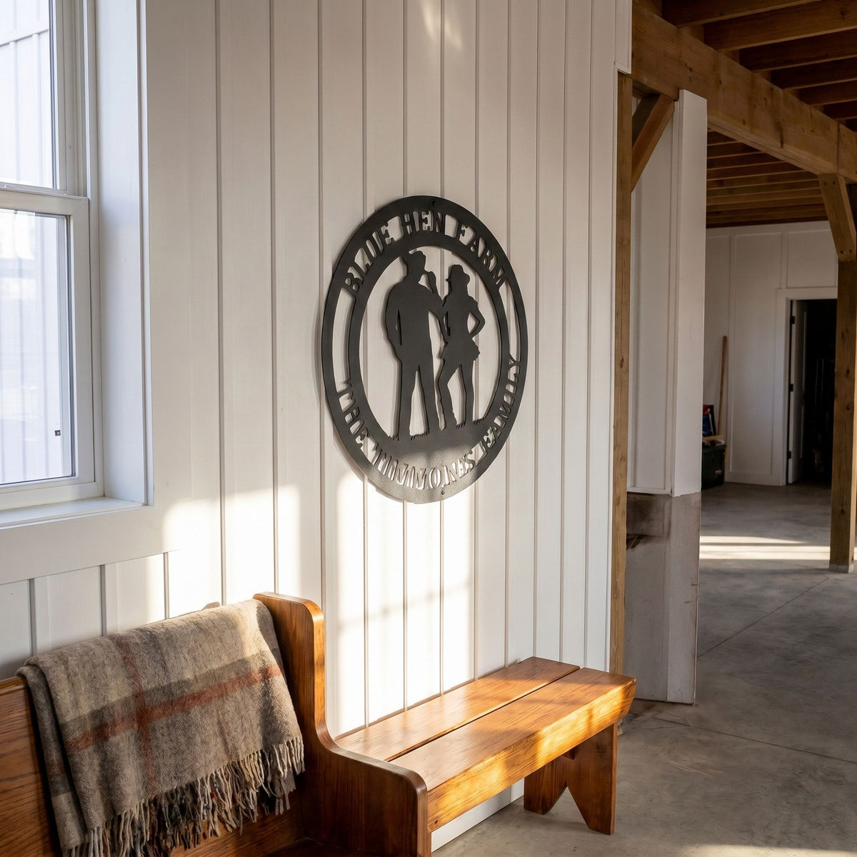 Custom cowboy and cowgirl metal wall art displayed in bright farmhouse hallway with wooden bench and rustic interior