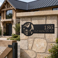 Black personalized rooster address sign mounted on stone pillar with custom house number old hickory road text and rustic country farm landscape design