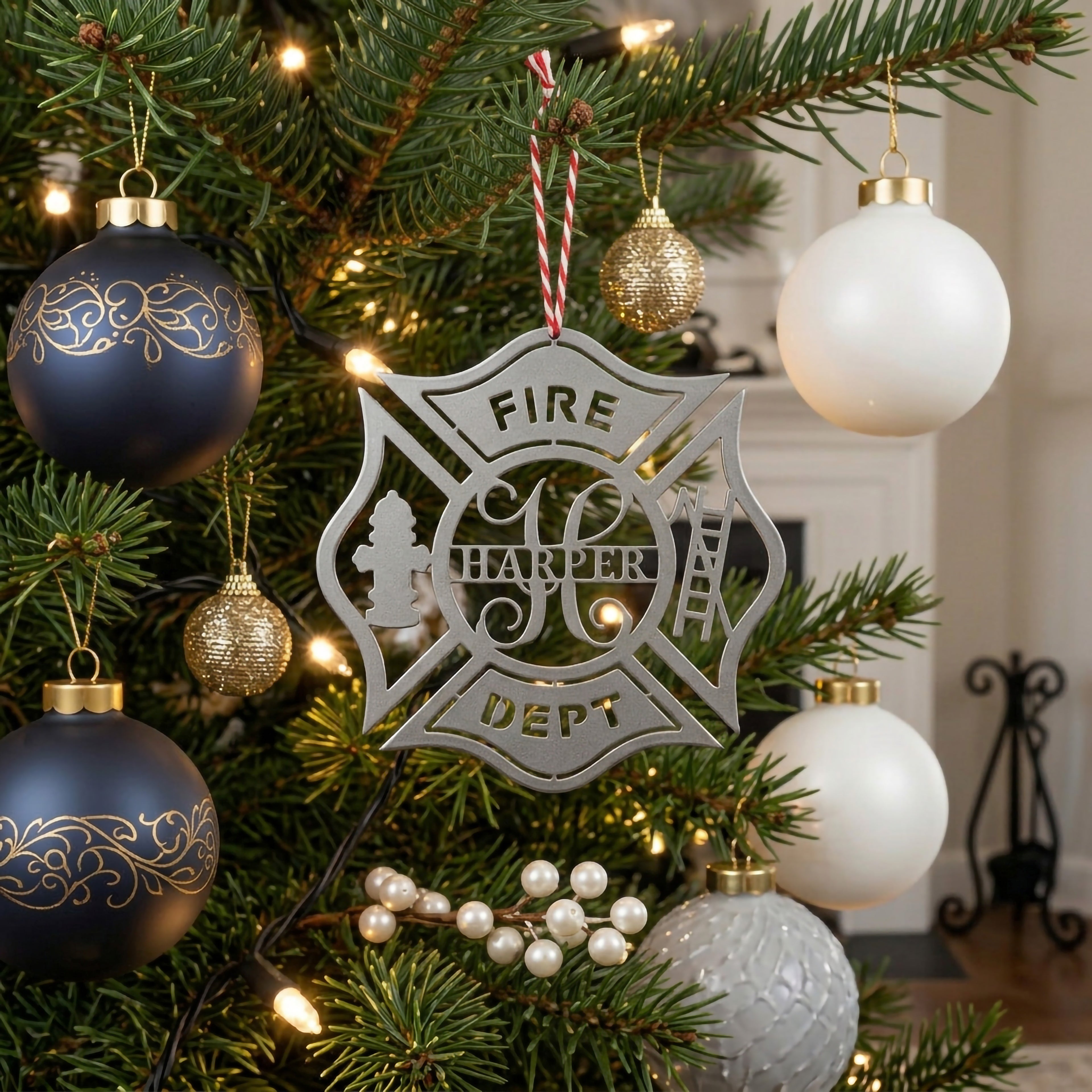 Personalized fire department ornament with firefighter themed design displayed on elegant Christmas tree with glowing lights and ornaments
