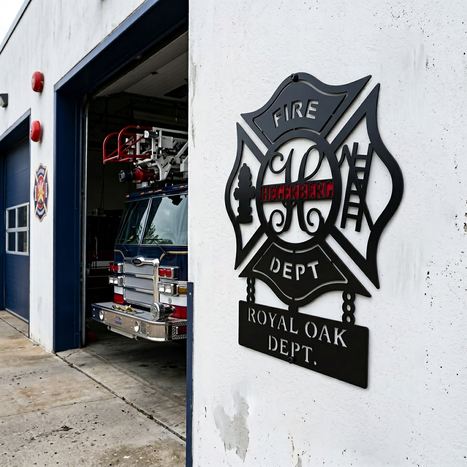 Custom firefighter maltese cross metal wall sign mounted outside fire station with fire truck in garage background