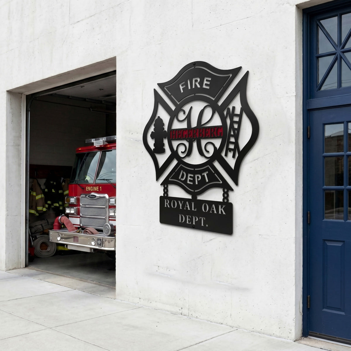 Black firefighter maltese cross metal sign displayed outside fire station beside fire engine bay and blue door