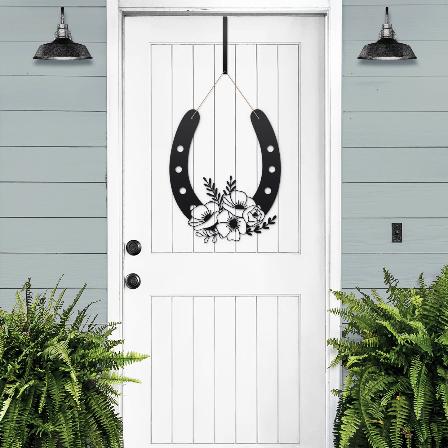 Floral Horseshoe Door Wreath featuring a black horseshoe adorned with floral elements on a white door, symbolizing good luck and charm, perfect for gardens, yards, or farms.