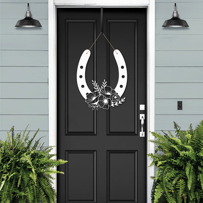 Floral Horseshoe Door Wreath - A black door adorned with a white horseshoe featuring floral accents, symbolizing good luck and elegance, perfect for outdoor decor and gifting.