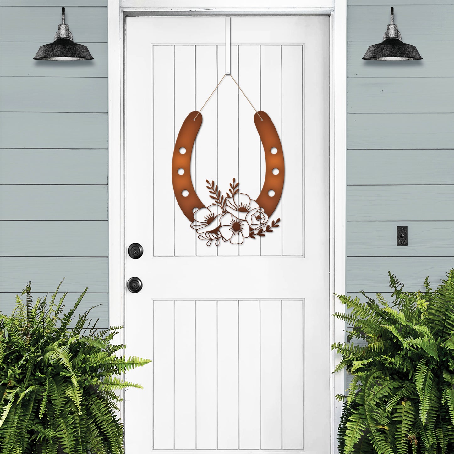 Floral Horseshoe Door Wreath displayed on a white door, showcasing its elegant design with metal floral accents, symbolizing good luck and charm, ideal for outdoor decor or as a housewarming gift.