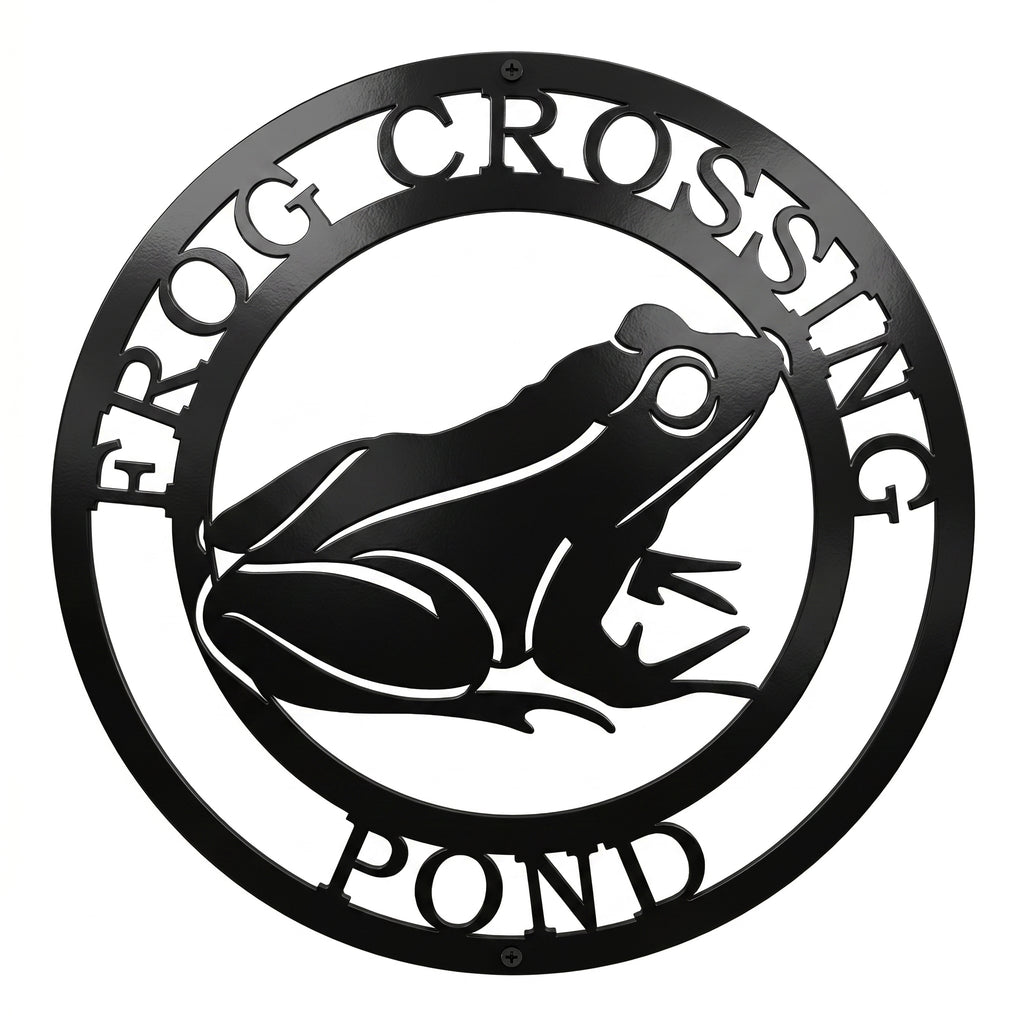 Black frog crossing pond metal wall art sign with circular nature design on white background