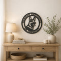 Black German Shepherd on premises metal wall sign displayed above wooden console table with neutral farmhouse decor