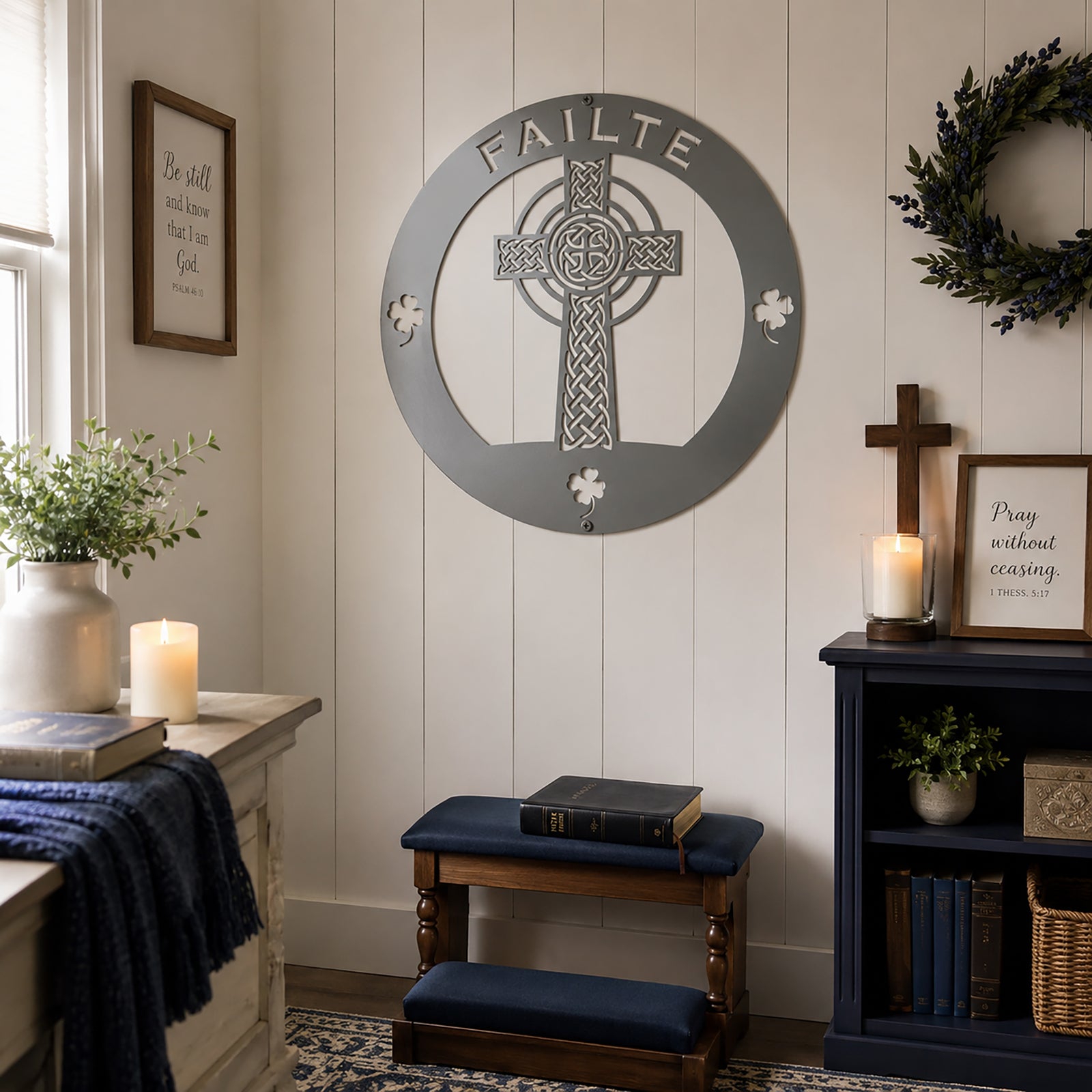 Grey Celtic cross metal wall sign with Irish shamrock accents displayed in a cozy faith inspired room setting