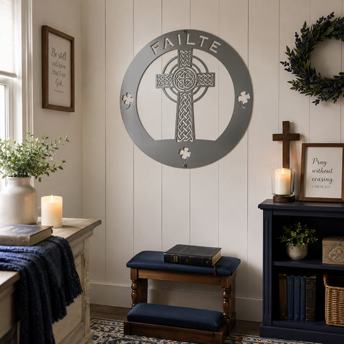 Grey Celtic cross metal wall sign with Irish shamrock accents displayed in a cozy faith inspired room setting