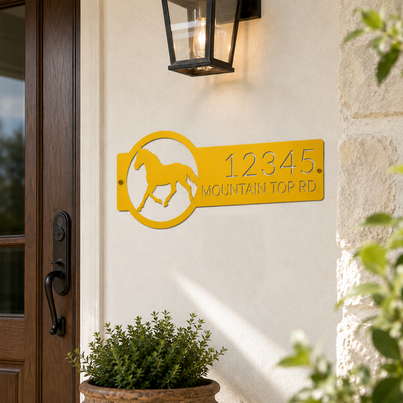 Golden yellow horse address metal sign displayed near rustic front door