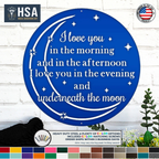 Blue round metal wall sign with moon stars and I love you quote displayed on white brick wall with color options for custom home decor gift or nursery wall art