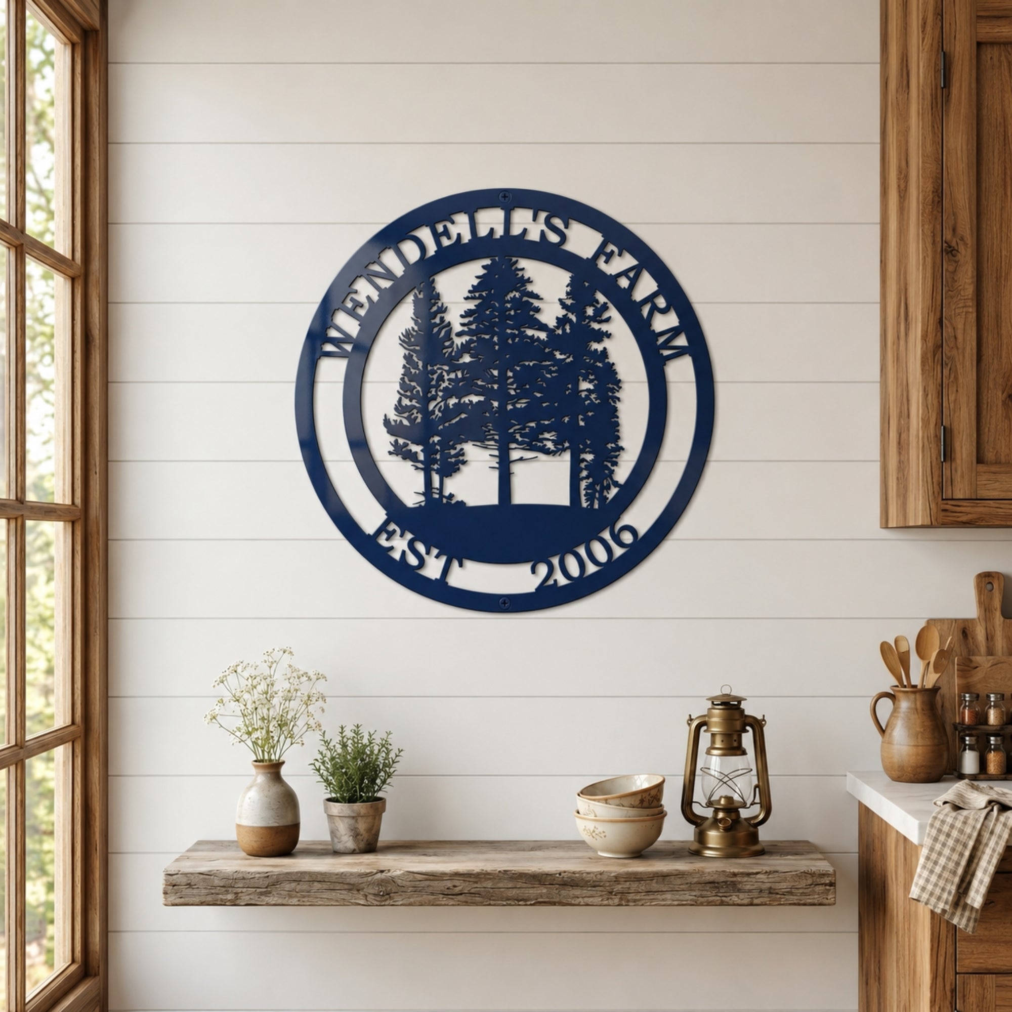 Round navy blue ranch metal wall décor with custom ranch name and EST 2021 displayed above wooden floating shelf in farmhouse kitchen