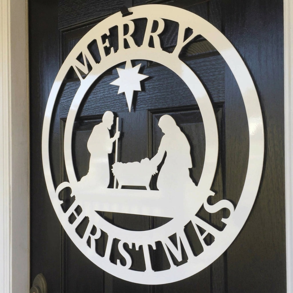 A white circular metal door sign featuring a silhouette of the nativity scene and "Merry Christmas" text on a black door.