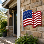 Metal American flag wall art displayed on stone exterior wall near front porch entryway