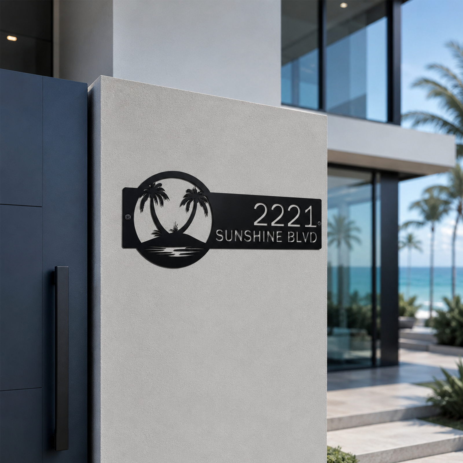 Black custom palm tree address sign mounted on white exterior wall of modern ocean view home