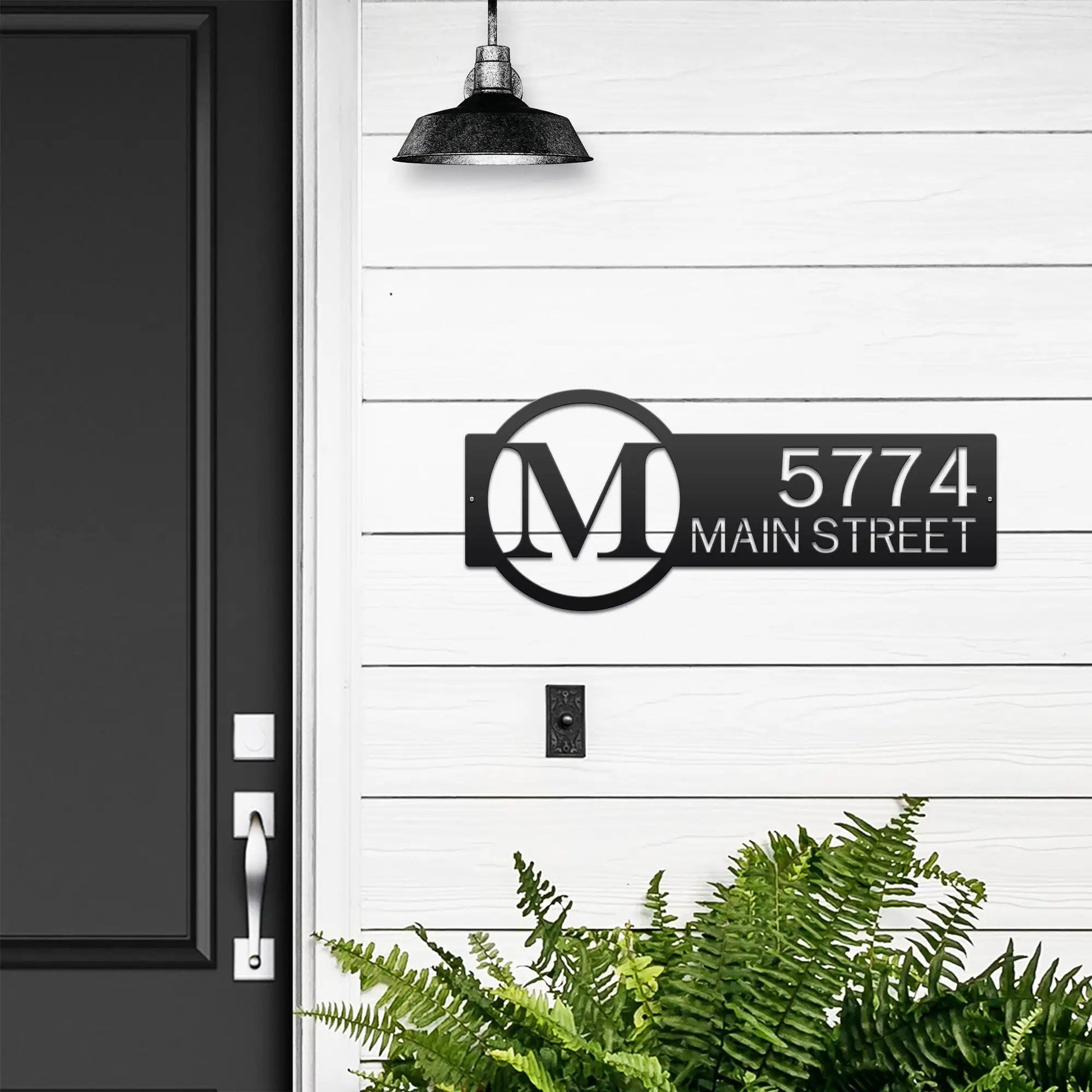 Metal Monogram Address Sign featuring custom house numbers and street name, expertly laser cut from steel, showcasing a classic monogram font on a black sign with white text for outdoor home décor.