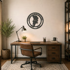 Black motorcycle metal wall art displayed above industrial office desk with rustic wood furniture and leather chair
