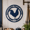 Navy blue rooster metal wall art displayed above farmhouse table with rooster themed country decor