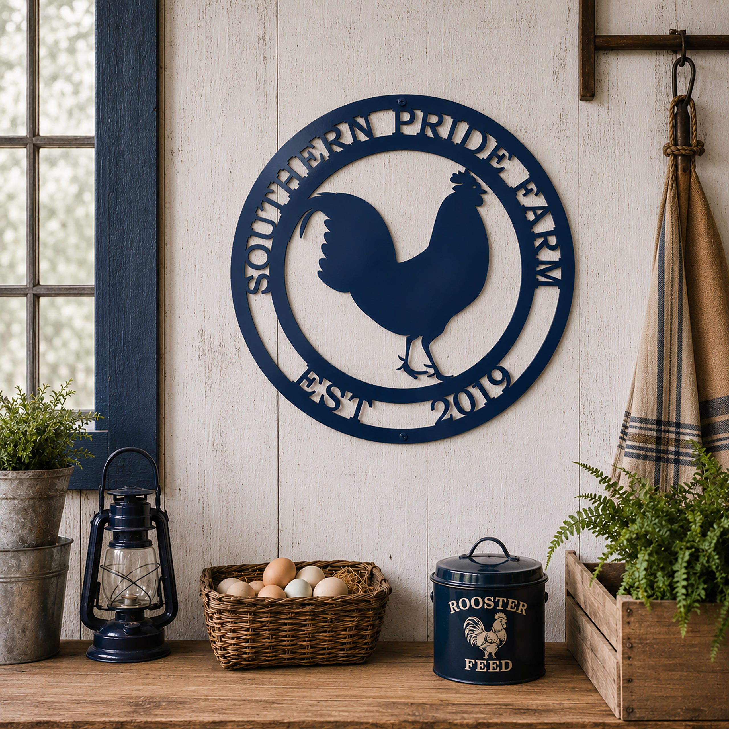 Navy blue rooster metal wall art displayed above farmhouse table with rooster themed country decor