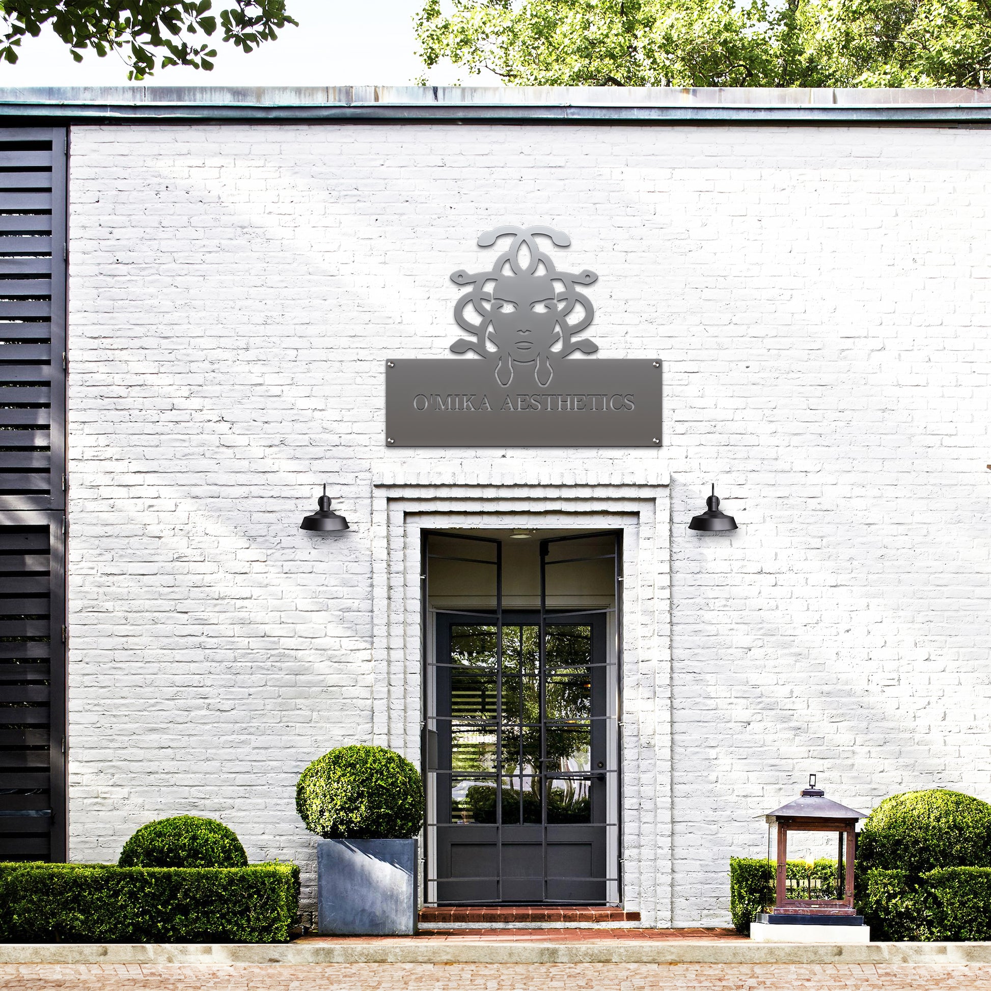 Custom STOREFRONT Brand/Business Logo Sign displayed on a white brick building exterior. The laser-cut metal sign, showcasing a company's logo, is designed for professional branding at offices or storefronts.