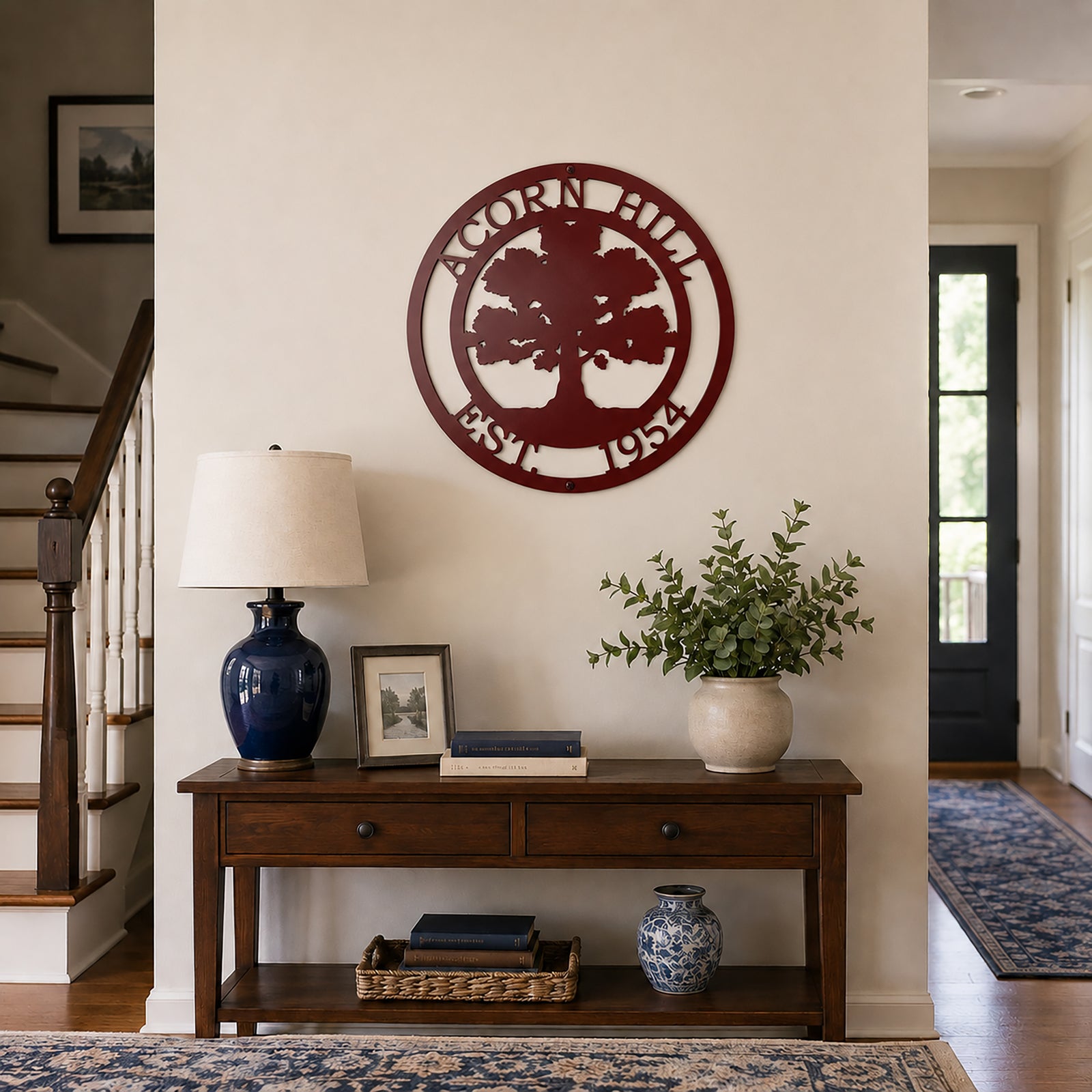 Maroon oak tree family name metal wall decor displayed above entry table