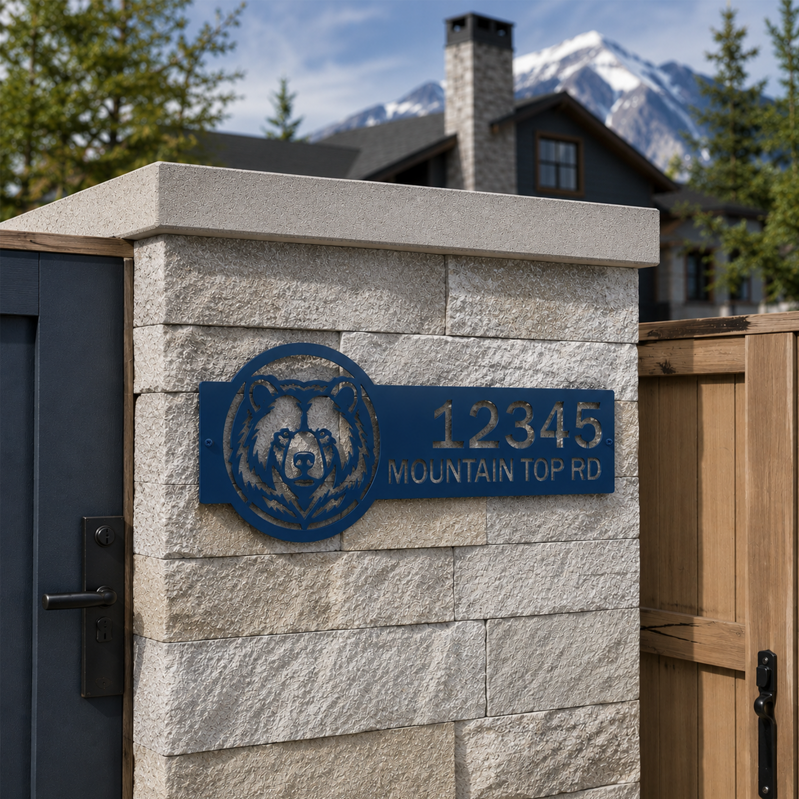 Ocean blue bear themed custom address sign mounted on white outdoor wall with mountain lodge background