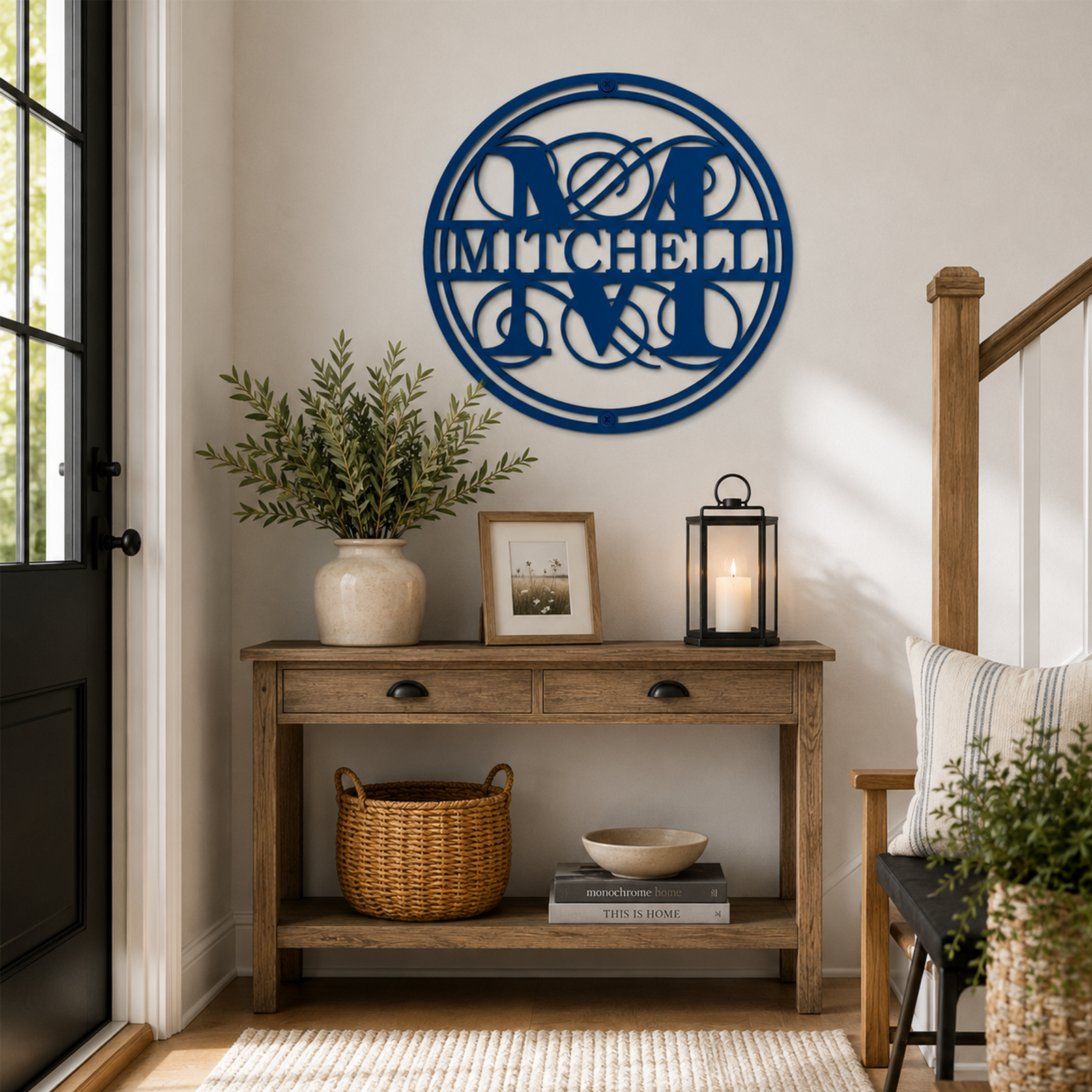 Ocean blue circular family name metal wall art with Mitchell monogram displayed in a cozy modern farmhouse entryway