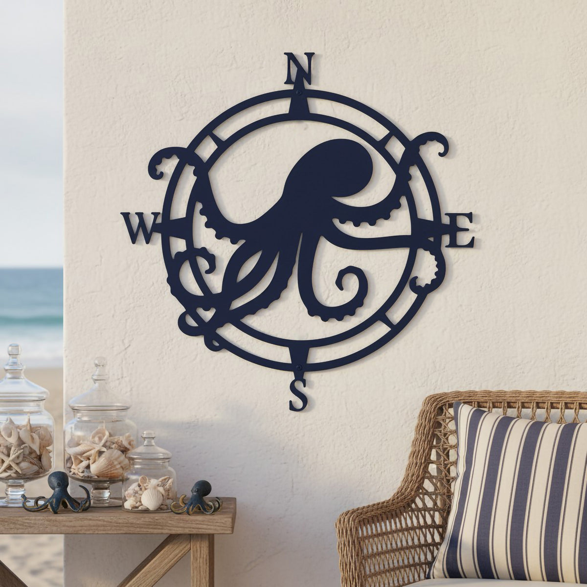 Navy octopus compass metal wall décor displayed in a beach house setting with seashell accents