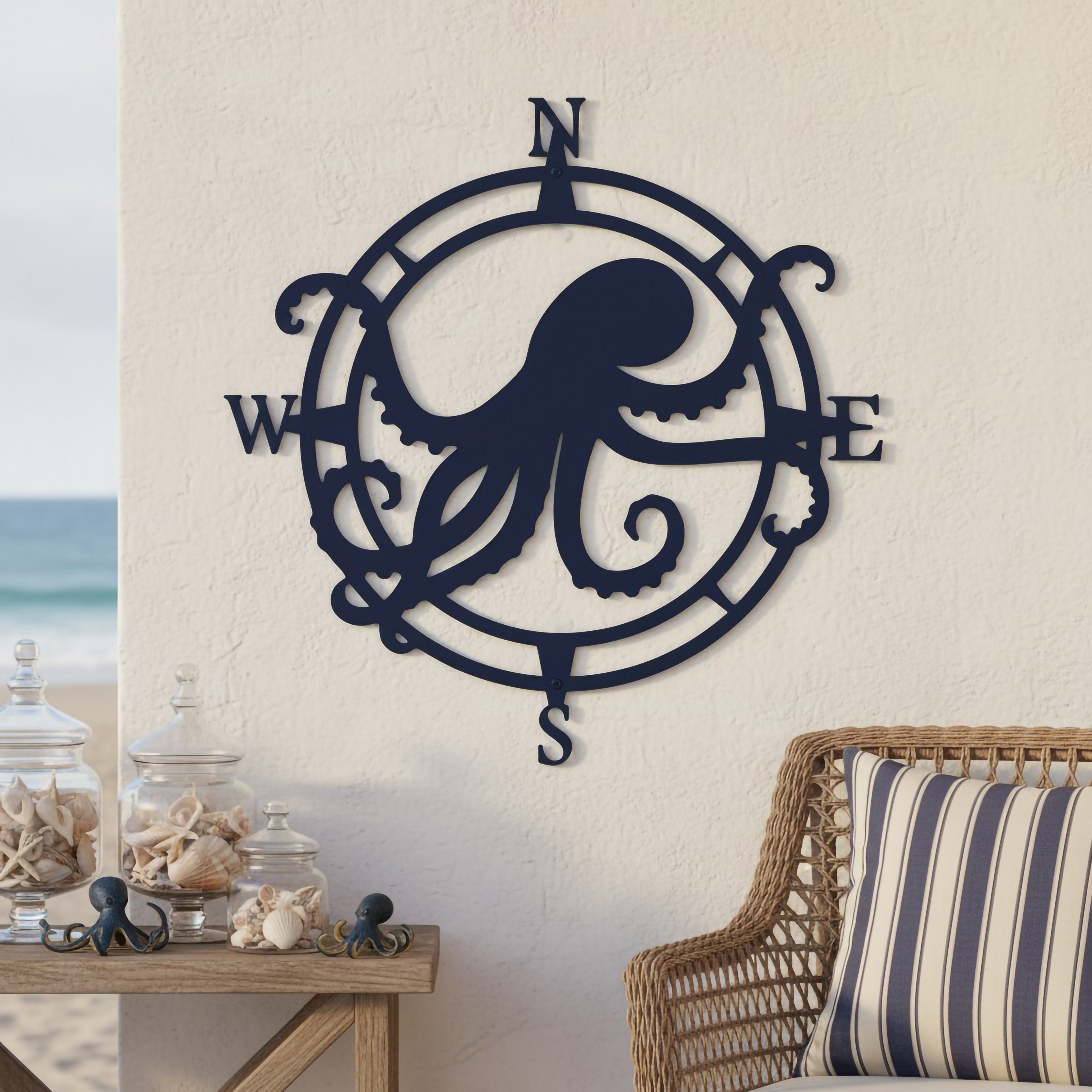 Navy octopus compass metal wall décor displayed in a beach house setting with seashell accents