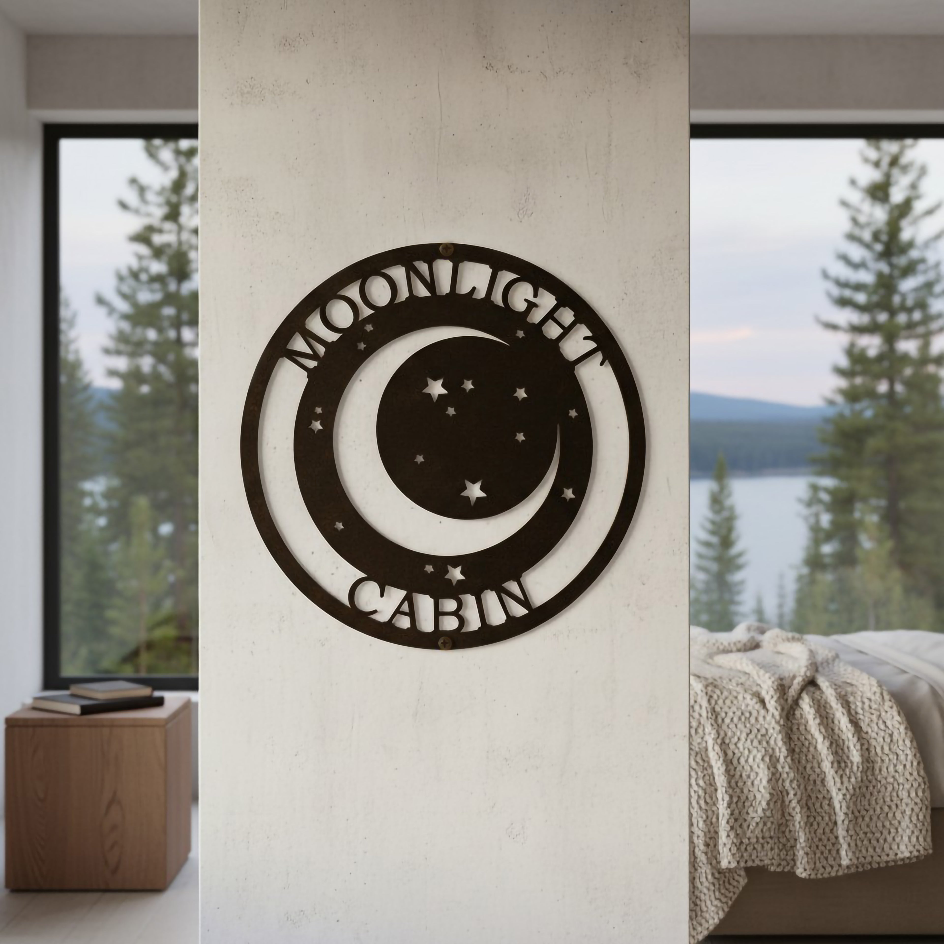 Oil rubbed bronze finish of the personalized round metal cabin sign mounted on a weathered white wood siding exterior wall near a balcony railing with a steaming black coffee