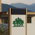 Green mountain metal house number sign with 5329 mounted on modern outdoor mailbox pillar with mountain backdrop