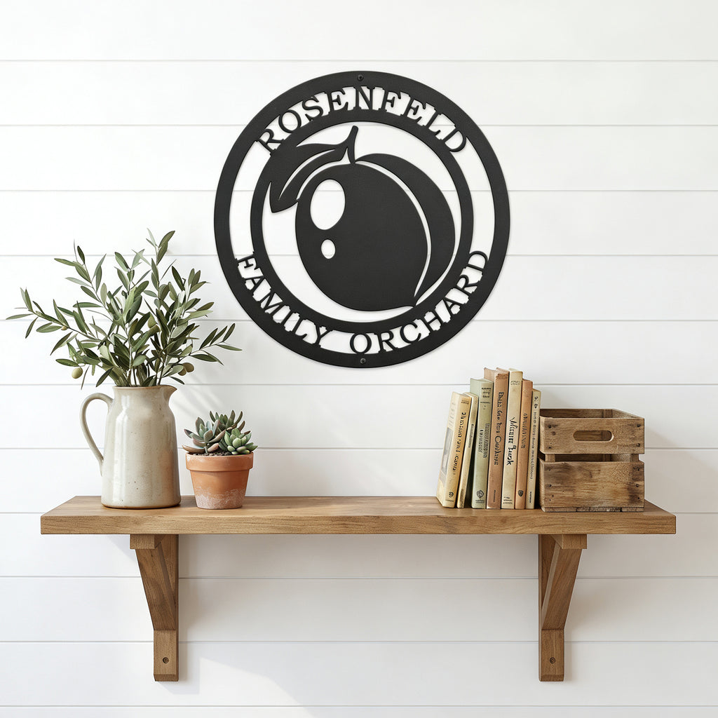 Personalized peach orchard metal wall art displayed above wooden shelf with books plants and farmhouse accents on white wall
