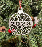 Decorative Christmas ornament with 2023 hanging on tree, festive holiday décor for seasonal display and commemorative ornament collection