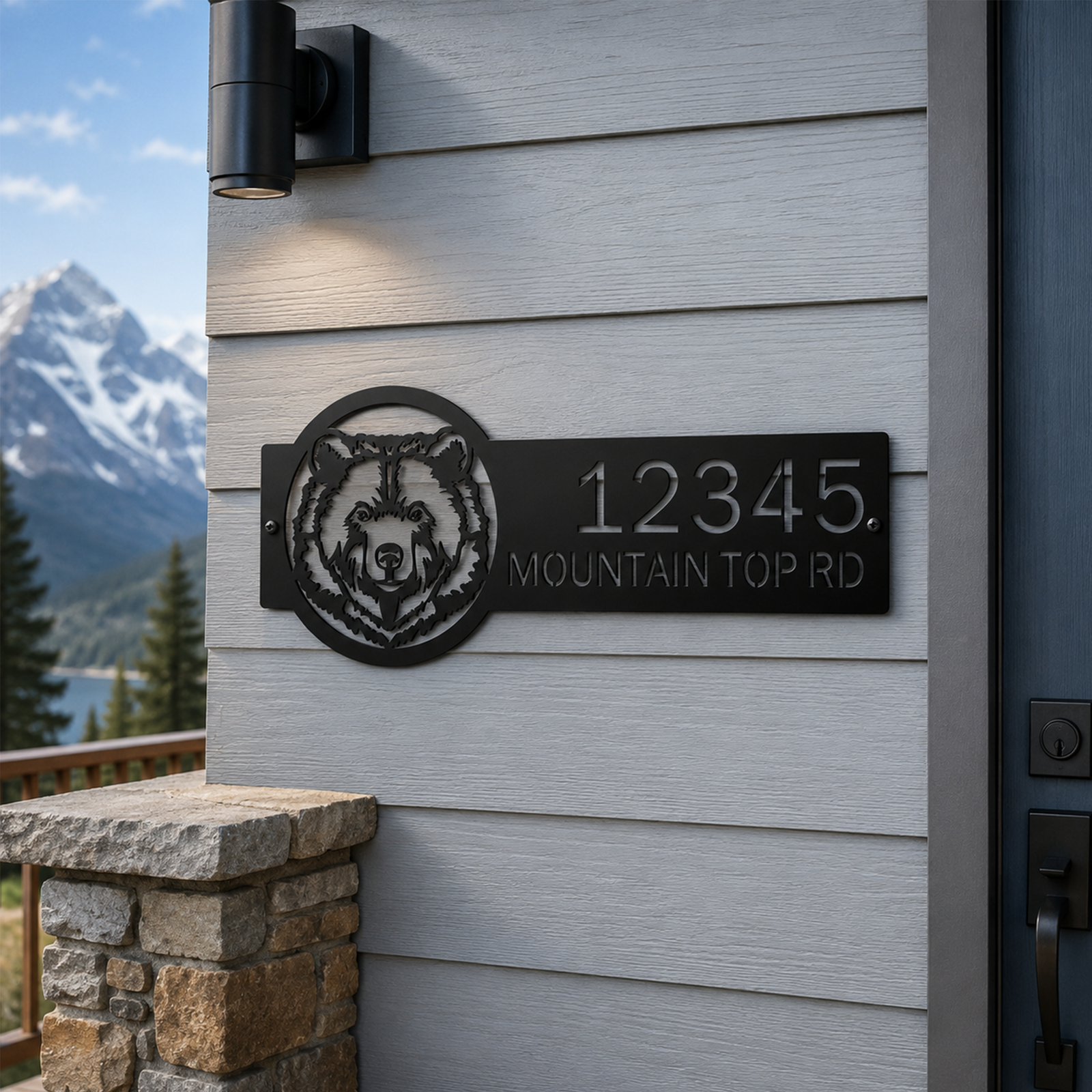 Black bear themed metal address sign with custom house numbers and mountain road text mounted on modern cabin wall