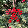 Red candy cane ornament hanging on Christmas tree, festive holiday decoration for seasonal décor and Christmas tree display