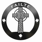 Black Celtic cross metal wall decor featuring the word Failte and shamrock accents on a circular frame