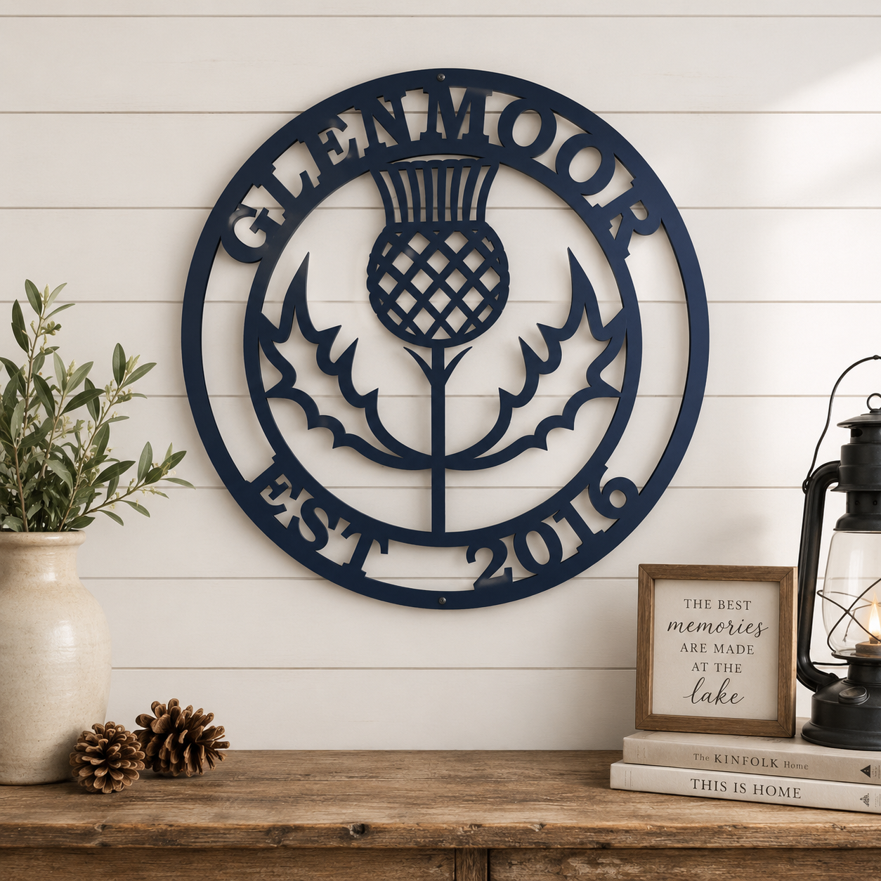 Close up of personalized Scottish thistle metal wall sign with custom family name and established year on rustic wood shelf background