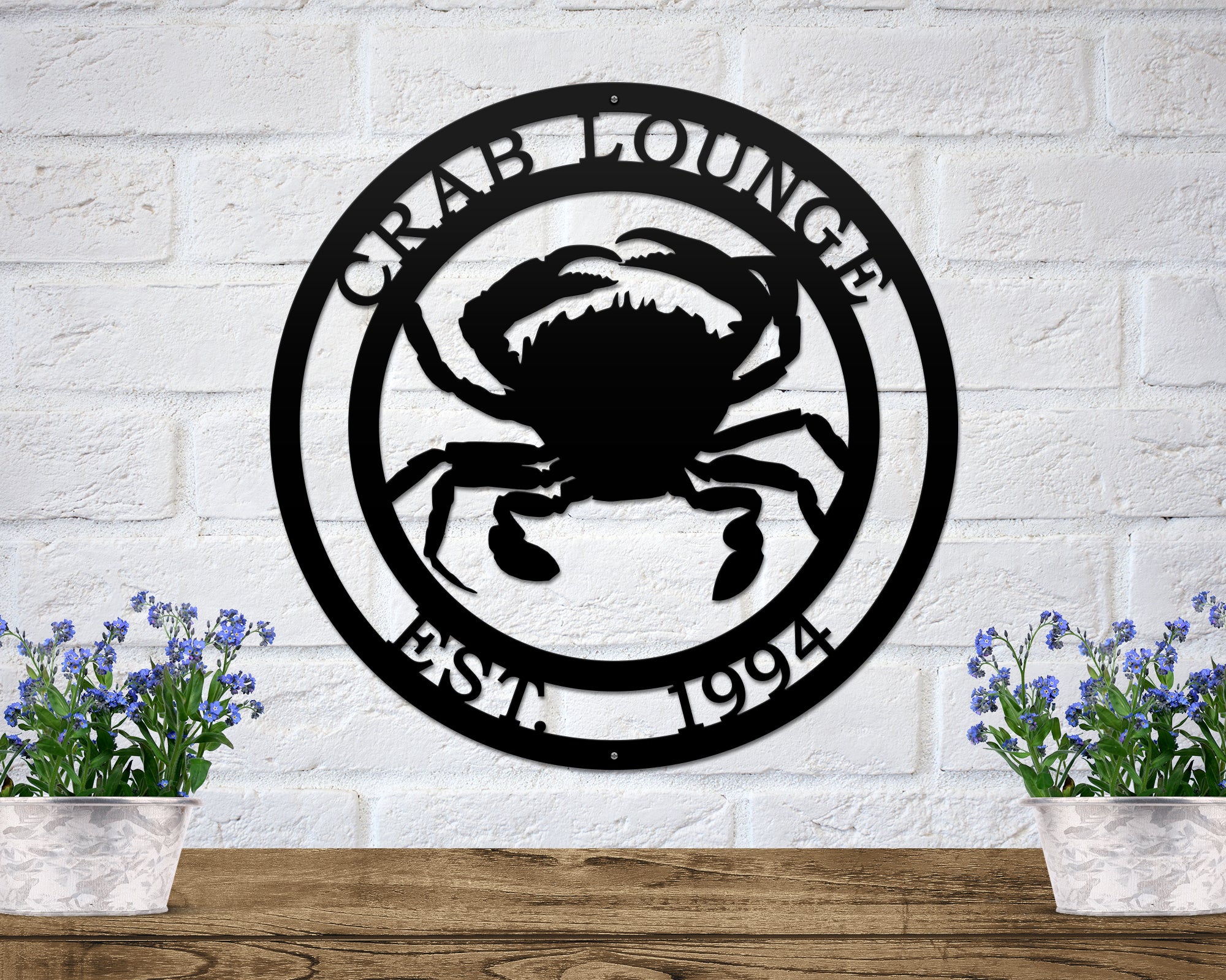 Black custom crab lounge metal wall sign with established year coastal beach house decor mounted on white brick wall