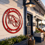 Candy apple red crawfish metal sign with The Lloyds and Est 2022 mounted on seafood shop exterior