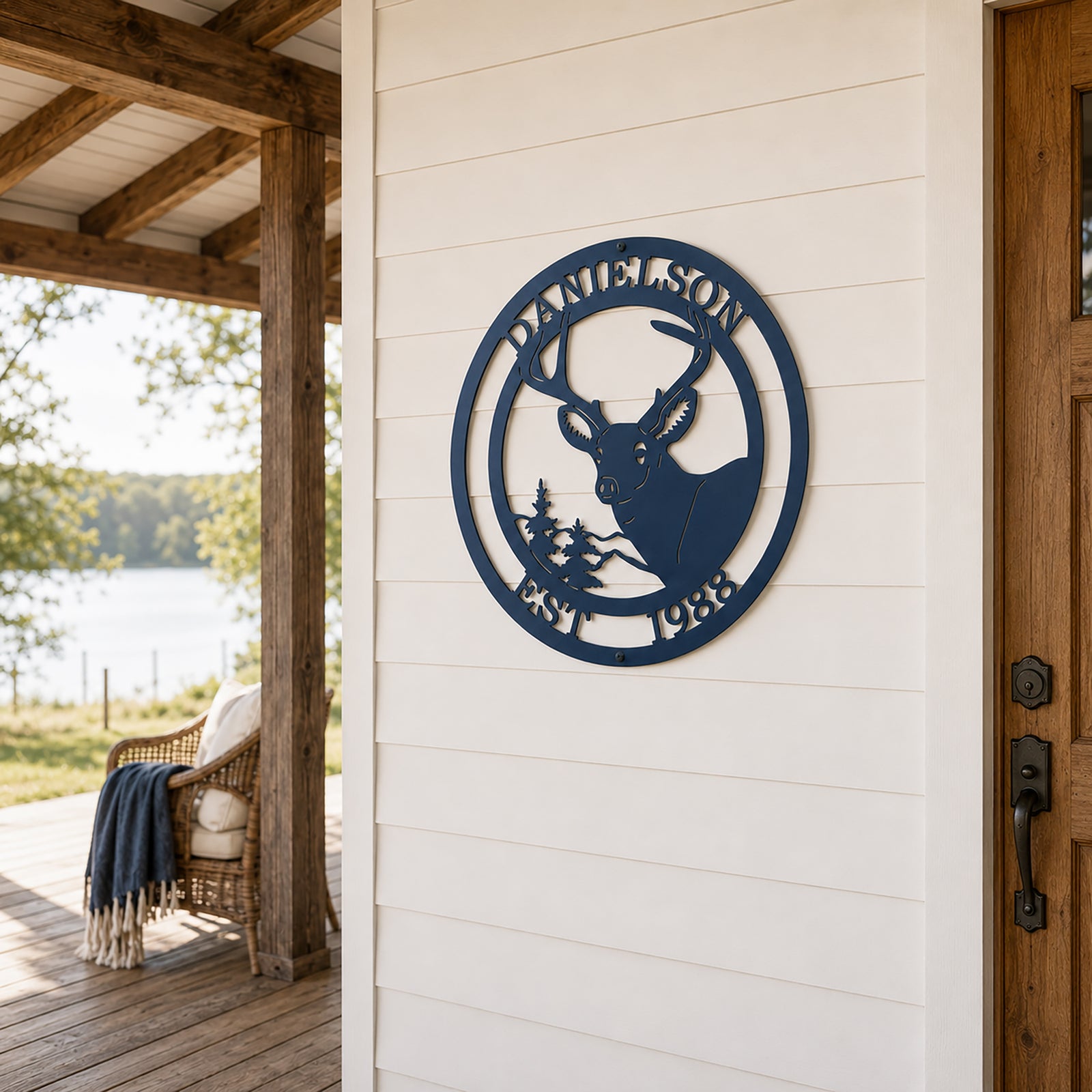 Navy blue deer metal wall sign with family name and established year mounted on modern farmhouse porch wall