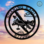 Custom round aviation metal sign featuring airplane silhouette clouds and personalized eagle hangar name with aircraft registration number against colorful sky background