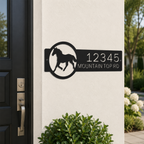 Black custom horse ranch metal address sign displayed beside front entry door