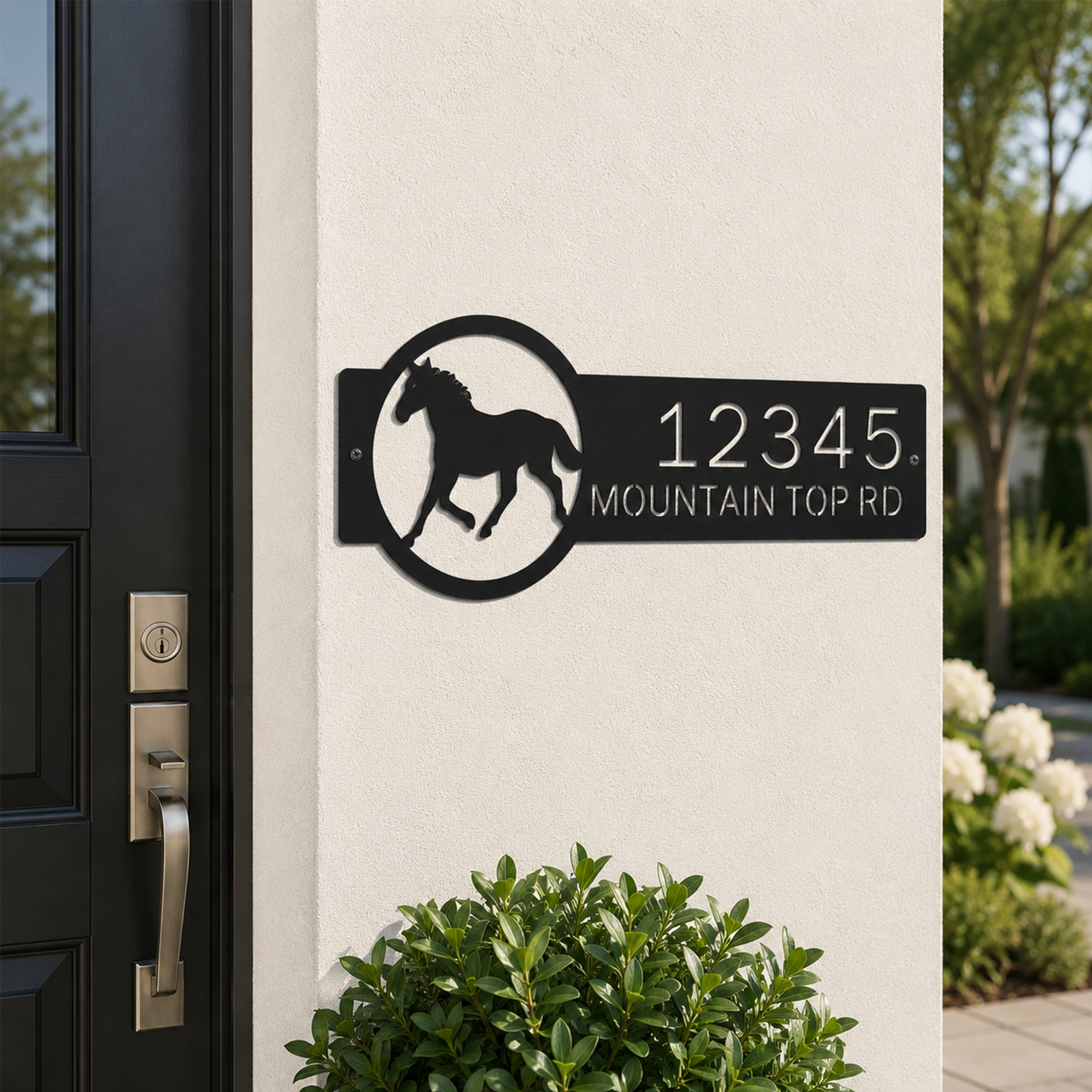 Black custom horse ranch metal address sign displayed beside front entry door