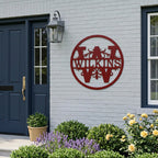 Black circular metal monogram wall sign featuring the Wilkinson family name displayed on a modern home exterior wall