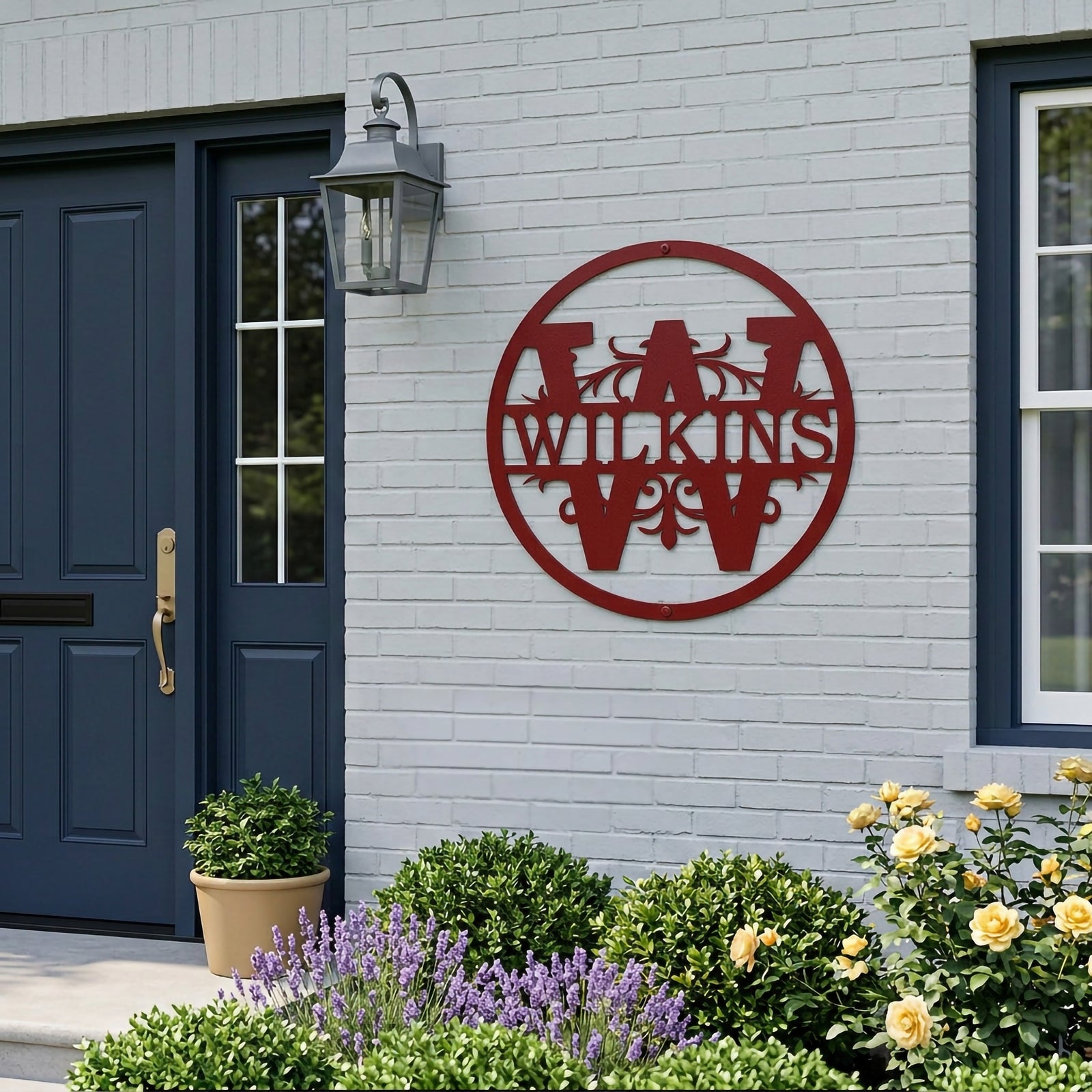 Black circular metal monogram wall sign featuring the Wilkinson family name displayed on a modern home exterior wall