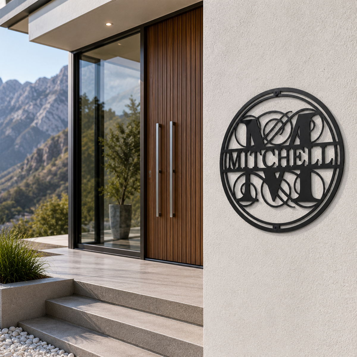 Black circular metal monogram wall sign featuring the Mitchell family name displayed outside a modern luxury home entrance