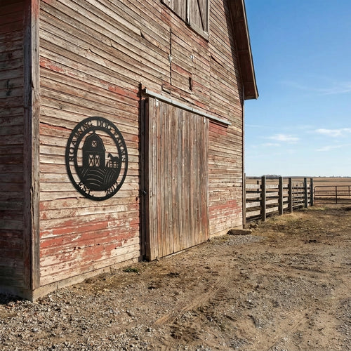 Black personalized farm barn metal wall sign mounted on rustic wooden barn exterior featuring countryside landscape and custom family name decor