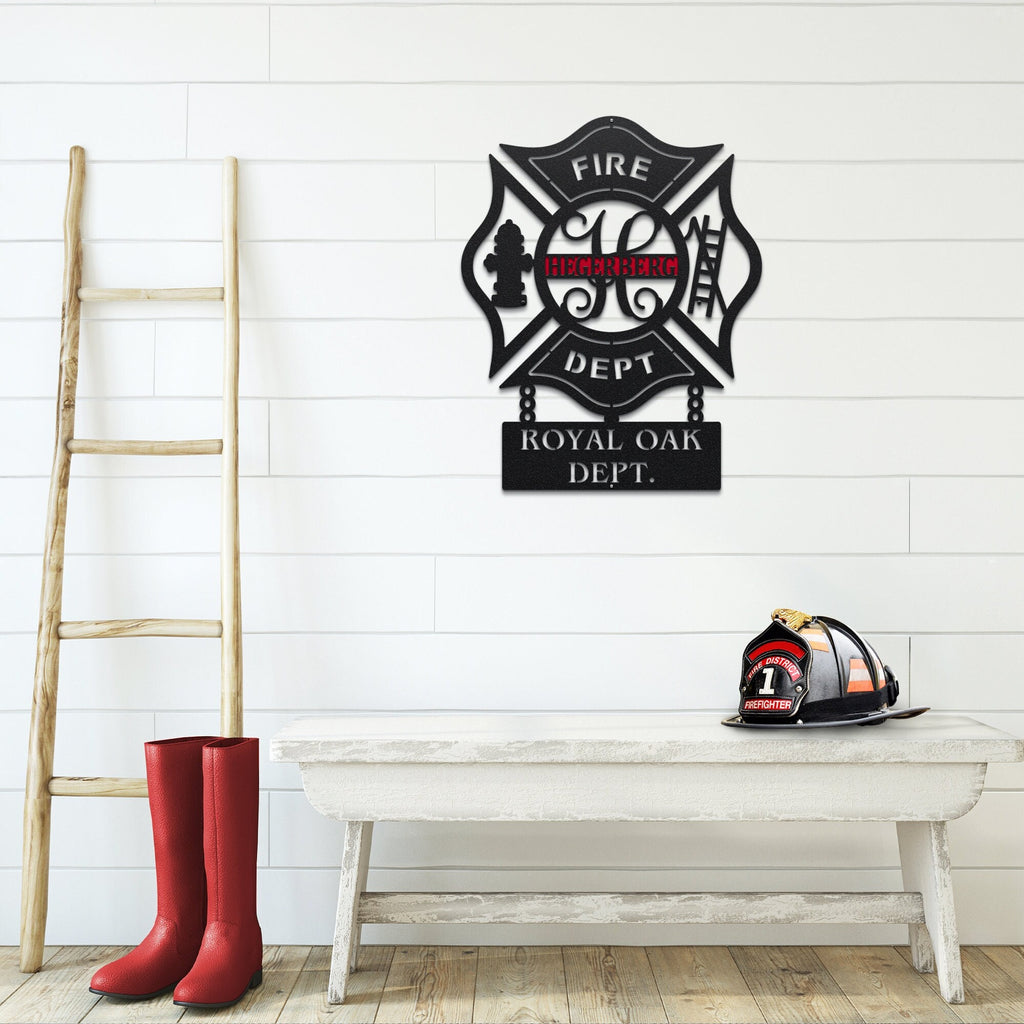 Personalized metal wall art of Fire department logo on a wall with red boots and a helmet on a bench below.