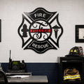 Large black firefighter Maltese cross metal sign with Fuller name mounted inside fire department office and equipment room