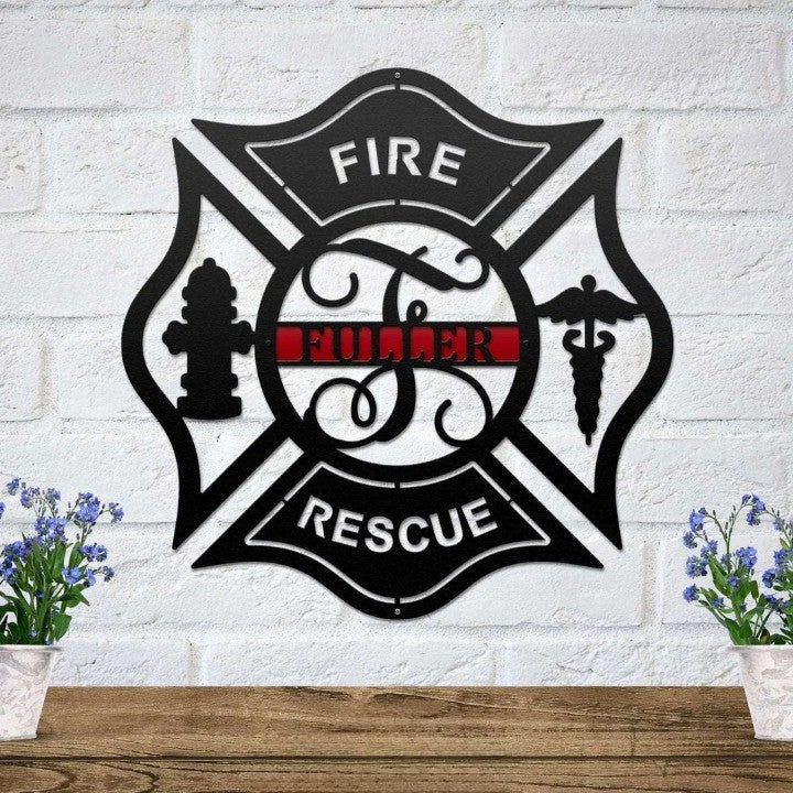 Black Maltese cross metal sign with a thin red line and custom name on a white brick wall above a wood shelf.