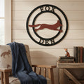 Custom fox den metal wall sign with black circular frame and rust fox design displayed on a cozy wood wall with rustic cabin decor